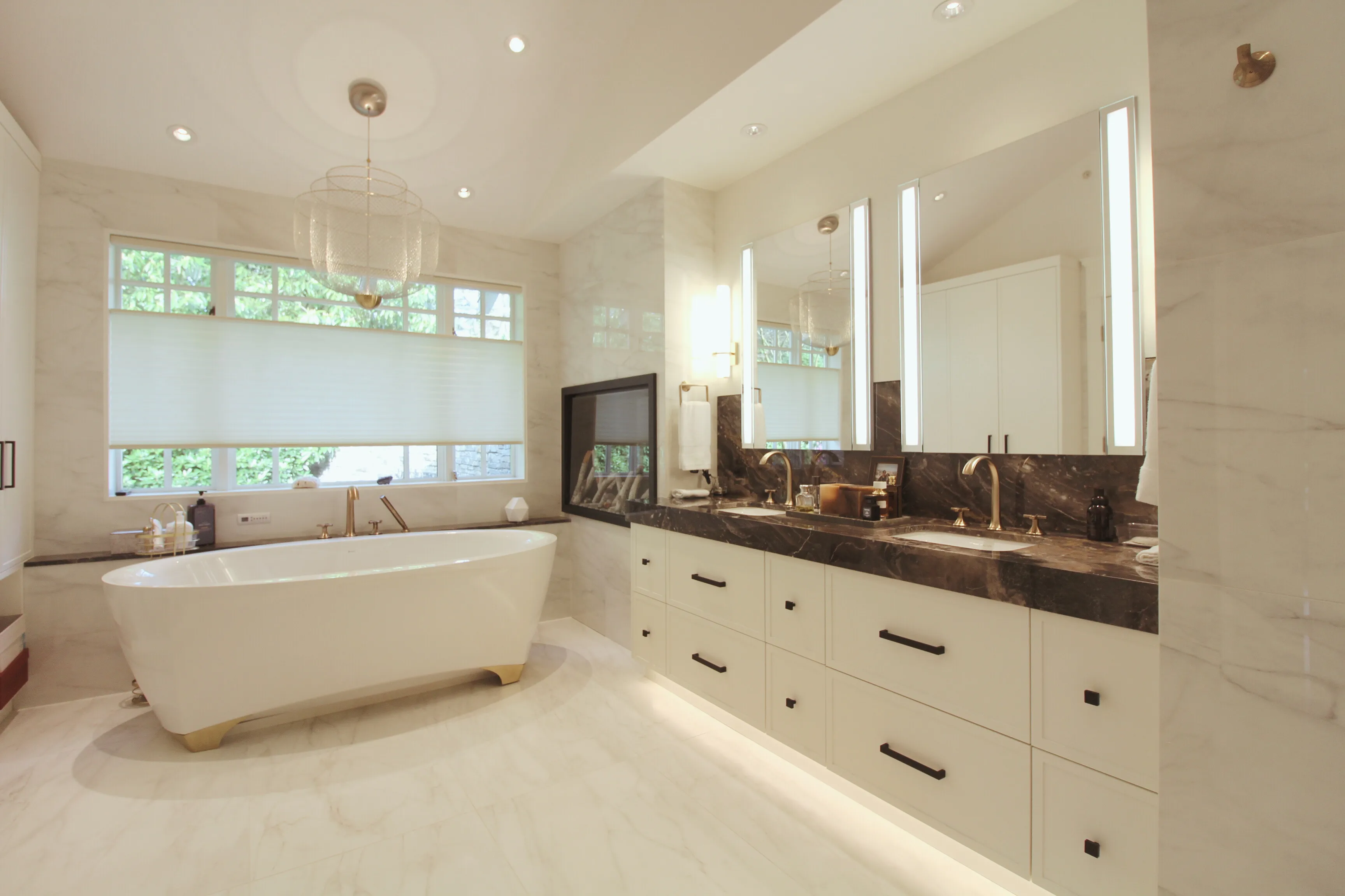 A spacious bathroom featuring a bathtub and a sizable mirror.